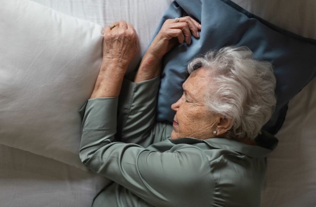 A senior sleeping soundly in bed.