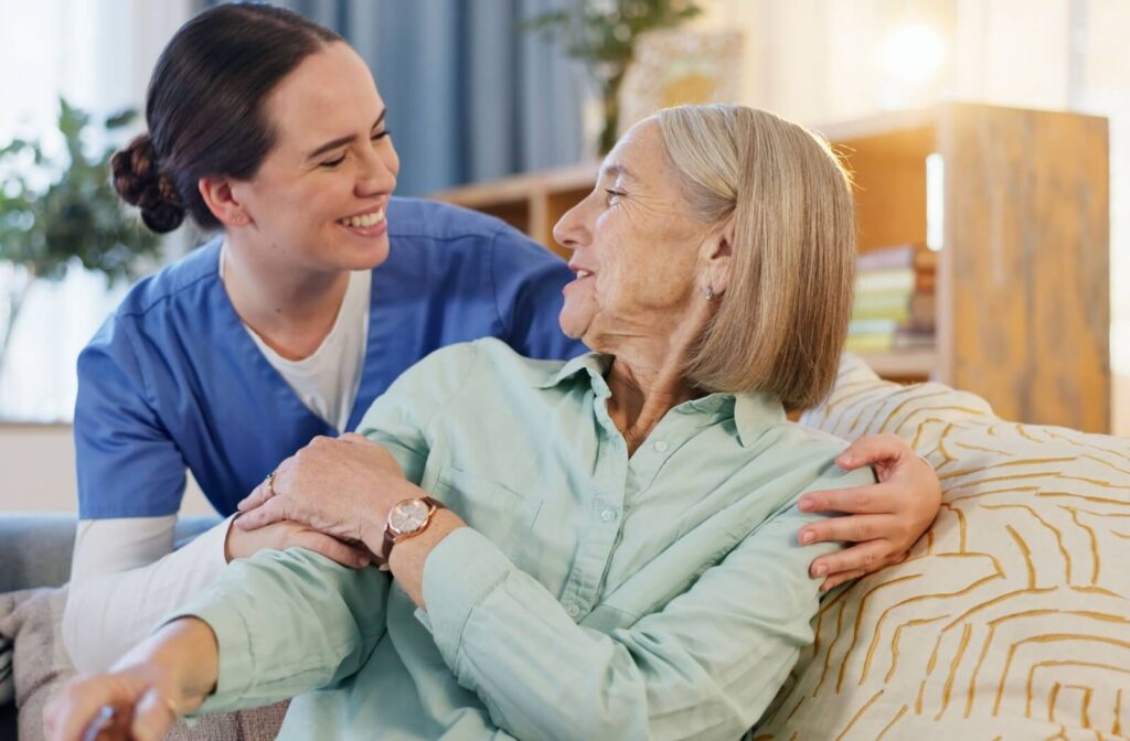 A patient in hospice care turns and smiles at a caregiver during a gentle check-in