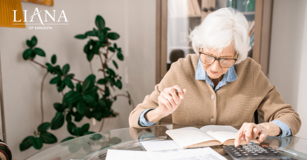 Someone with dementia reviewing household bills with a calculator at home
