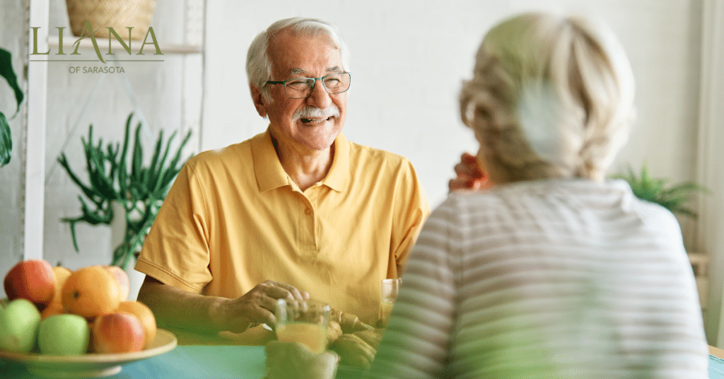 A smiling seniors living with dementia enjoying refreshments at home