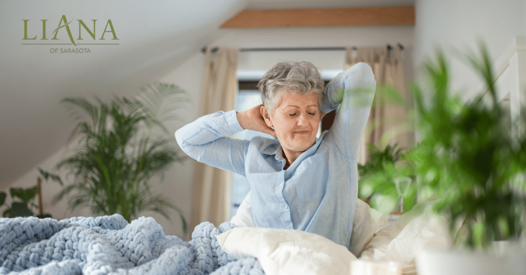 Older woman stretching in bed after restful sleep, supporting daily wellness and maintaining brain health