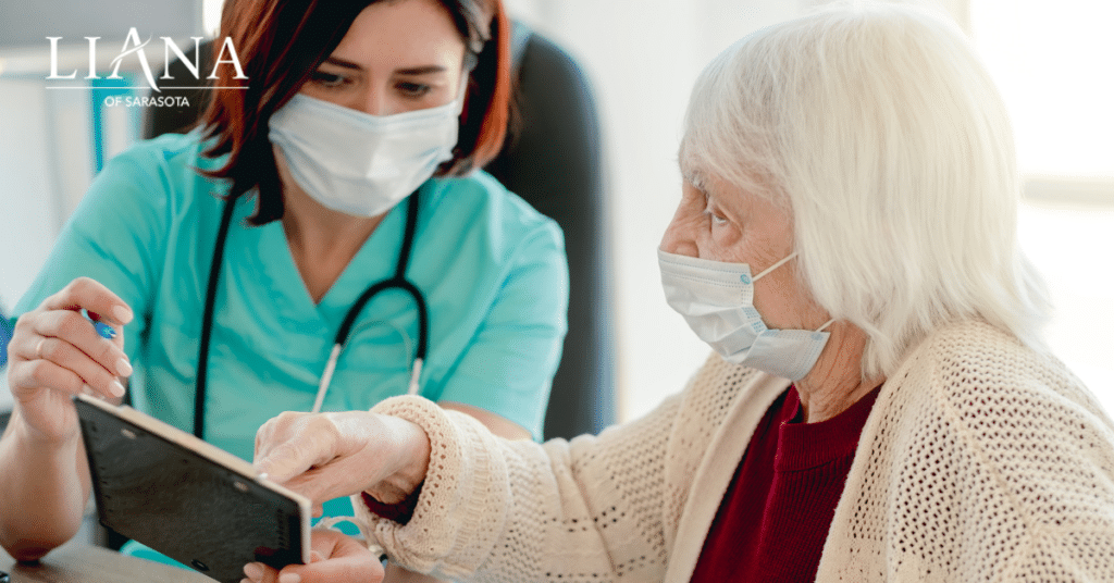 A doctor guiding a senior through a 5 word memory test during a medical consultation.