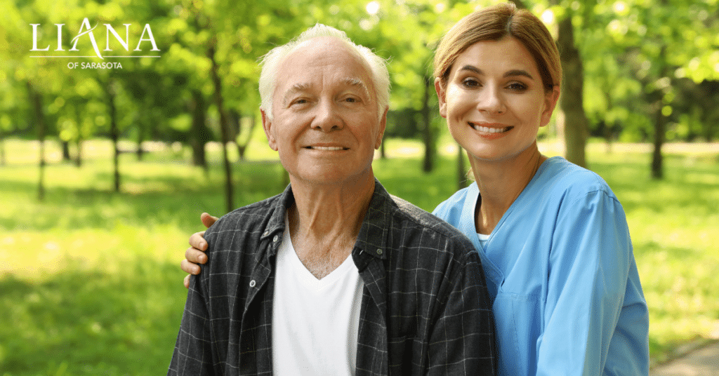 Older man sitting with a smiling caregiver outdoors, representing different types of caregivers for seniors