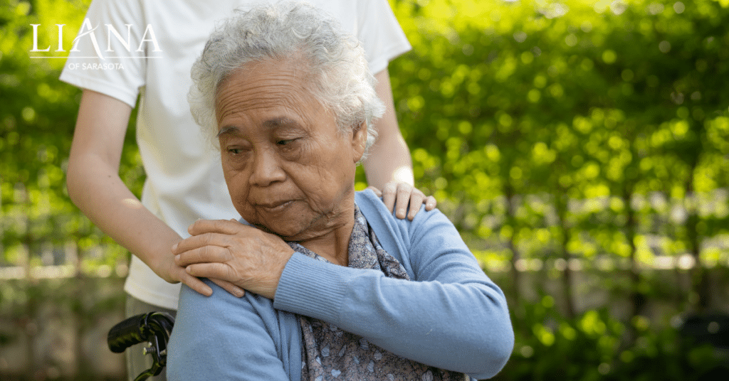A senior woman with a care partner in a garden