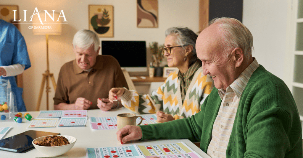 Seniors enjoying memory-friendly activities with a care partner during a relaxed bingo game in a welcoming community setting.