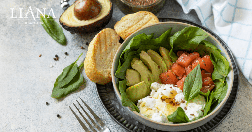Salmon and avocado salad with spinach and seeds, featuring nutrient-rich foods to prevent Alzheimer's.