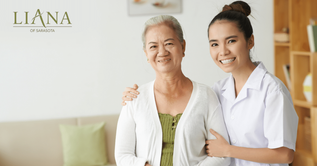 A care partner supporting an older woman in a bright living room through personalized memory care services