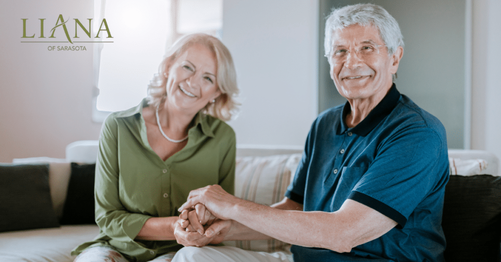 Senior couple holding hands at home, highlighting companionship and support during Alzheimer’s care at home
