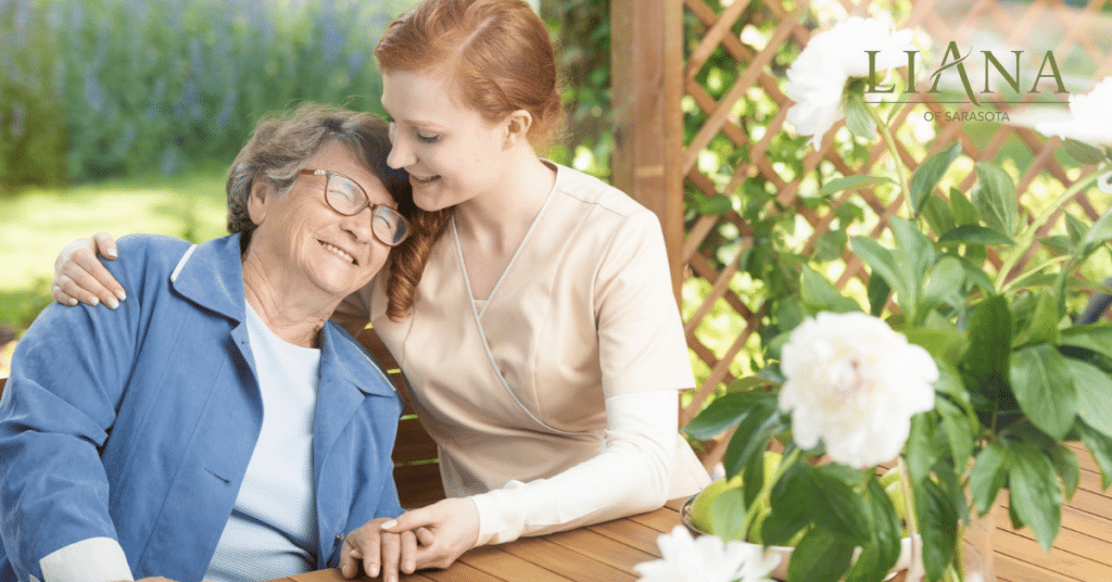 A care partner is providing gentle companionship to an older woman outdoors as part of dementia care for the elderly